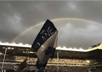  ?? FRANK AUGSTEIN/THE ASSOCIATED PRESS ?? Fans invade the pitch somewhere under the rainbow after Tottenham’s White Hart Lane swan song on Sunday.