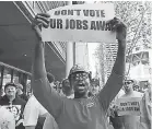  ??  ?? Ironworker Adilson Correia, currently helping build the Amazon Block 20 office building, rallies at Seattle City Hall. Correia opposes the tax. AP