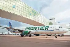  ?? JEREMY DWYER-LINDGREN FOR USATODAY ?? A Frontier Airbus A321 passes under the pedestrian bridge at Denver Internatio­nal Airport. Frontier is adding 85 routes.