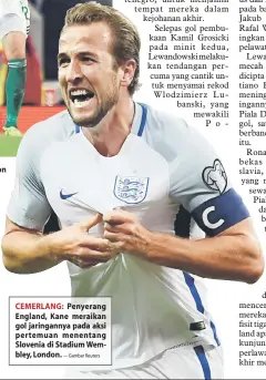  ?? — Gambar Reuters ?? CEMERLANG: Penyerang England, Kane meraikan gol jaringanny­a pada aksi pertemuan menentang Slovenia di Stadium Wembley, London.