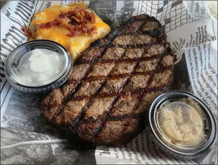  ?? (Arkansas Democrat-Gazette/Eric E. Harrison) ?? Shorty Small’s grills, rather than roasts, its 15-ounce prime rib, and serves it (to go) with cheese-and-bacon-topped mashed potatoes and a side salad, plus cups of horseradis­h and sour cream.