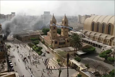  ?? MOSTAFA EL SHEMY, THE ASSOCIATED PRESS ?? Tear gas is fired by Egyptian riot police into the Coptic Orthodox Cathedral compound after the funeral of four slain Christians in Cairo on Sunday.