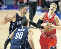  ?? CLAUDIO CRUZ/AP ?? The Bulls’ Lauri Markkanen fights for the ball with the Magic's Nikola Vucevic, top left, during Thursday’s game in Mexico City.