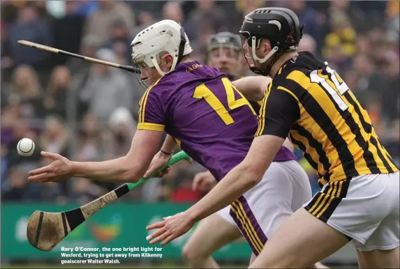  ??  ?? Rory O’Connor, the one bright light for Wexford, trying to get away from Kilkenny goalscorer Walter Walsh.