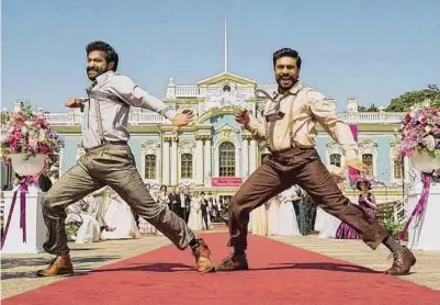  ?? Variance Films ?? N.T. Rama Rao Jr., left, and Ram Charan Teja dance as if their lives depend on it in “RRR.”