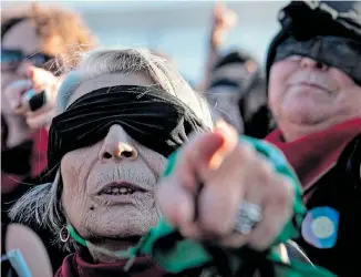  ?? Picture: MARTIN BERNETTI/AFP ?? NO MORE: An elderly woman joins thousands of women in the choreograp­hed ‘The rapist is you’ against gender violence at Chile’s National Stadium in Santiago