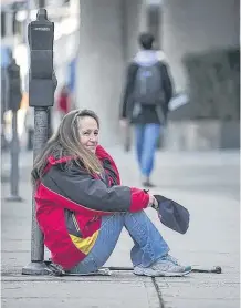  ??  ?? Tamara Loyer panhandles on Cordova street in Vancouver in 2014.