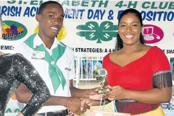  ?? FILE PHOTOS ?? Dishon Francis receives the St Elizabeth 4-H Clubs top boy of the year award from Miss Jamaica Festival Queen Ackera Gowie.
LEFT: Ackera Gowie, the reigning Miss Jamaica Festival Queen.