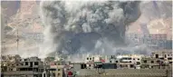  ?? - AFP ?? BILLOWING SMOKE: Smoke billows following a reported air strike in the rebel-held parts of the Jobar district, on the eastern outskirts of the Syrian capital Damascus, on Monday.