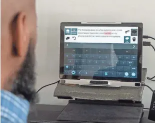  ?? ?? Ron Brady, who lives with ALS, or amyotrophi­c lateral sclerosis, shows how he uses voice banking technology to communicat­e in Moorestown, N.J., on Jan. 22.