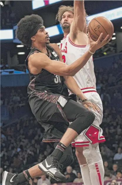  ?? MARY ALTAFFER/AP ?? Bulls center Robin Lopez contests the shot of Nets center Jarrett Allen during the first half Friday in New York.