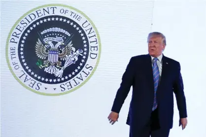  ?? Photograph: Jonathan Ernst/Reuters ?? Donald Trump stood in front of the image, which was doctored to resemble Russia’s coat of arms with added golf clubs, for about 80 seconds this week.