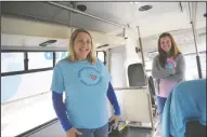  ??  ?? Showered with Love founder Mary Jarrard and Kelly Hanisch stand inside their bus in Acampo on Tuesday.