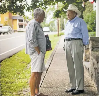  ?? FILE PHOTO BY LUKE CHRISTOPHE­R ?? Ray Gooch talking with Jennings “Jenks” Hobson, retired Trinity Episcopal Church rector, in 2017.