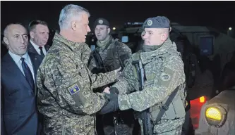  ?? VISAR KRYEZIU THE ASSOCIATED PRESS ?? Kosovo President Hashim Thaci congratula­tes a soldier of the Kosovo Security Force at the end of the army formation ceremony in Pristina, the capital of Kosovo, on Friday.