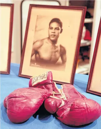  ?? REUTERS ?? The boxing gloves that heavyweigh­t champion Joe Louis used in his first fight against Germany’s Max Schmeling in 1936 are shown at the Smithsonia­n’s National Museum of American History in Washington.