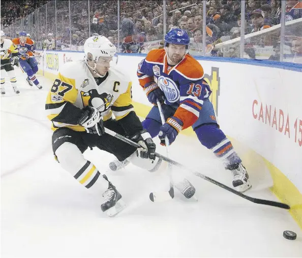  ?? JASON FRANSON/THE CANADIAN PRESS ?? Penguins superstar Sidney Crosby tries to take the puck away from Edmonton’s David Desharnais during Friday night’s contest at Rogers Place. The visiting Penguins prevailed 3-2 in a shootout to end a thoroughly entertaini­ng night of NHL hockey.