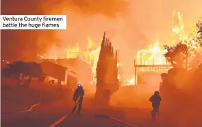 ??  ?? Ventura County firemen battle the huge flames