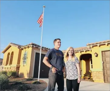  ?? Glenn Koenig Los Angeles Times ?? JOSH AND KAYLEIGH Hyink, in their mid-20s, ditched their one-bedroom apartment in Orange County to buy their first home in Murrieta, where they purchased a brand-new, three-bedroom house for $430,000.