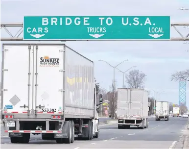  ??  ?? Transport trucks approach the Canada-U.S. border crossing in Windsor, Ont. The border between the two countries closed to most travellers in March, but remains open to people and businesses providing essential services.