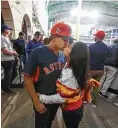  ?? Steve Gonzales / Houston Chronicle ?? Carlos Perez and his wife, Alice, share a kiss before Game 3 of the World Series at Minute Maid Park.