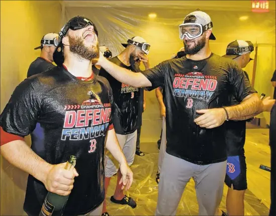  ?? Frank Franklin II Associated Press ?? BOSTON RELIEVER Ryan Brasier, left, celebrates the American League East title with Brandon Workman and teammates. Brasier was promoted to majors in July.