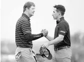  ?? HARRY HOW/GETTY IMAGES ?? Hudson Swafford, left, shakes with Dominic Bozzelli on the 18th hole after winning on Sunday in La Quinta, Calif.