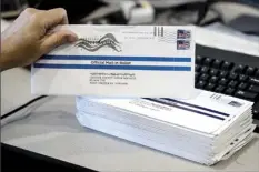  ?? AP photo ?? Dave Turnier processes mail-in ballots at at the Chester County Voter Services office in West Chester, Pa., prior to the primary election May 28. President Donald Trump’s campaign and allies have blocked efforts to expand mail-in voting, forcing an awkward confrontat­ion with top GOP election officials promoting the opposite in their states.