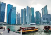  ?? AFP ?? The financial district in Singapore. The country’s GDP rose an annualised 0.1 per cent in the three months through March. —