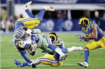  ?? [AP PHOTO] ?? Dallas Cowboys running back Ezekiel Elliott (21) was held to 47 rushing yards in a 30-22 loss to the Los Angeles Rams on Saturday.