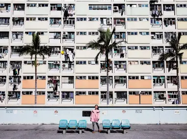  ??  ?? A woman poses for a photo at a popular Instagram spot in Hong Kong. — AFP