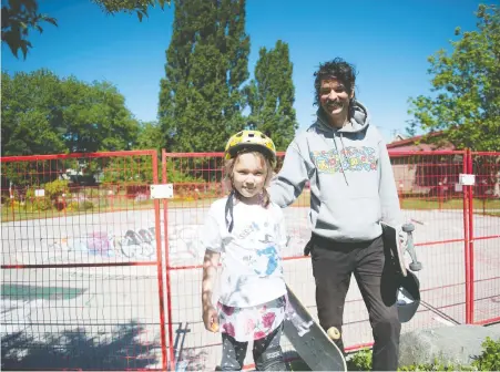  ?? MIKE BELL ?? Jeffry Lee, an avid skateboard­er, visits the fenced-off skateboard bowl at China Creek Park in Vancouver on Tuesday with his daughter Irene. Lee says he is frustrated that Vancouver has not reopened skate parks in the city when other municipali­ties have.