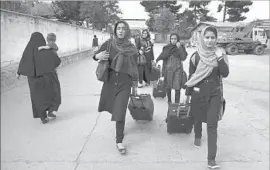  ?? Rahmat Gul Associated Press ?? MEMBERS OF the team arrive from Herat province to receive visas from the U. S. embassy in Kabul, thanks to interventi­on by the Trump administra­tion.