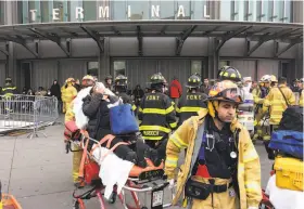  ?? Mark Lennihan / Associated Press 2017 ?? An injured passenger is taken from a Brooklyn terminal after a Long Island Railroad train crashed last year, killing one person and injuring some 200.