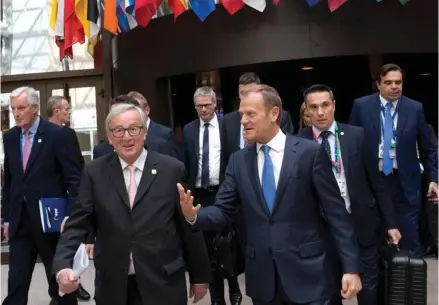  ?? Virginia Mayo, AP) (Photo by ?? From left, EU Chief Brexit negotiator, Michel Barnier, European Commission President Jean-Claude Juncker and European Council President Donald Tusk make their way to a media conference at an EU summit in Brussels on Saturday, April 29, 2017. EU leaders...