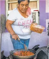  ?? DOROTHY EDWARDS, NAPLES DAILY NEWS ?? Macrina Cruz cooks the last of her family’s food on a portable stove in Immokalee. The town lost power when the storm hit.