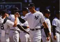  ?? John Minchillo / Associated Press ?? Yankees right fielder Aaron Judge takes the field with his teammates before the opening-day game against the Red Sox on Friday in New York.