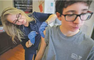  ?? ASSOCIATED PRESS FILE PHOTO ?? Wendy Kerley gives Ethan Getman, 15, a shot of the flu vaccine in 2019 at the Cordova Shot Nurse clinic in Memphis, Tenn. A second wave of flu is hitting the U.S., turning this into one of the nastiest flu seasons for children in a decade.