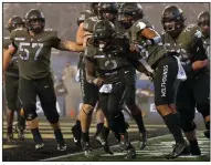  ?? (AP/Adam Hunger) ?? Army quarterbac­k Tyhier Tyler (center) celebrates after scoring a touchdown during the second half Saturday against Navy at Michie Stadium in West Point, N.Y. The Black Knights won 15-0 in the first meeting between the teams at West Point since 1943.