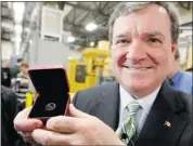  ?? Ken Gigliotti/winnipeg Free Press ?? Finance Minister Jim Flaherty displays the last penny struck, part of a one-million penny lot back in May.
