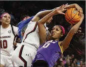  ?? NELL REDMOND – THE ASSOCIATED PRESS ?? South Carolina forward Aliyah Boston, center, strips the ball from LSU forward Angel Reese during Sunday’s game.