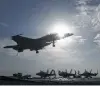  ?? Associated Press file photo ?? A Navy fighter jet lands on the USS Dwight D. Eisenhower. A reader quotes Eisenhower on military armaments.