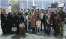  ?? Photograph: The Guardian ?? Mohammad Elmi, center back in red, said goodbye to friends and family at the airport in Tehran before leaving for California.