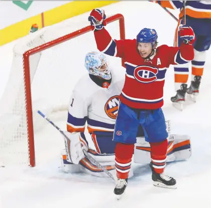  ?? PIERRE OBENDRaUF ?? Montreal’s Brendan Gallagher celebrates goal by Phillip Danault in front of New York Islanders goaltender Thomas Greiss at the Bell Centre on Tuesday. The Canadiens ended their eight-game losing streak with a 4-2 win over the Islanders.