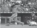  ??  ?? The Diamondbac­ks’ Carson Kelly watches his go-ahead solo home run in the sixth inning against the Rockies in Denver on Monday night.