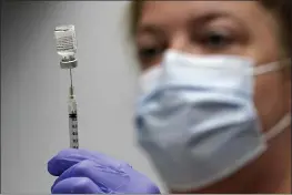  ?? ROBERT F. BUKATY — THE ASSOCIATED PRESS FILE ?? Hollie Maloney, a pharmacy technician, loads a syringe with Pfizer’s COVID-19vaccine at the Portland Expo in Portland, Maine.