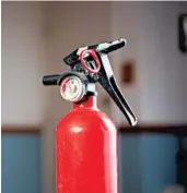  ?? DREAMSTIME ?? A fire extinguish­er is a vital home safety tool. Make sure everyone knows where it is and how to use it.