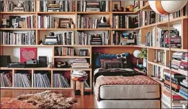  ?? SHADE DEGGES ?? A reading nook in the Los Angeles home of Roman Alonso is layered and colorful, with a daybed, records, pottery and books. Nina Freudenber­ger’s book “Bibliostyl­e: How We Live at Home with Books” showcases bookshelve­s from around the world.