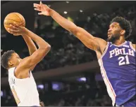  ?? Seth Wenig / Associated Press ?? The 76ers’ Joel Embiid tries to block a shot by Knicks guard Frank Ntilikina during the second half Sunday.