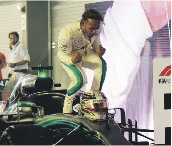  ?? AFP ?? Lewis Hamilton celebrates after his convincing win in yesterday’s Singapore Grand Prix